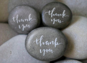 Three stones with "thank you" written on them