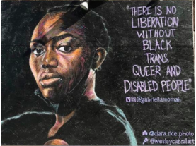 Description Credit Mia Mingus: A mural by artist Wesley Cabral in Hayes Valley featuring a portrait of Gabriella Momah that shows the Black nonbinary-identifying artist with the words, “There is no liberation without Black trans, queer, and disabled people” with their Venmo and Instagram handle @gabriellamomah. Below in the corner are the handles of the photographer, @clara.rice.photo, and painter @wesleycabralart, with small painted camera and paint brush icons respectively. The text is painted in purple against a black background. Momah is wearing a black shirt and has a black face mask secured over their ears and pulled down so it sits below their chin. They are positioned sideways with their face turned slightly away, but their eyes are looking directly at the viewer, the light at their back. Photo of mural by Tony Bravo.